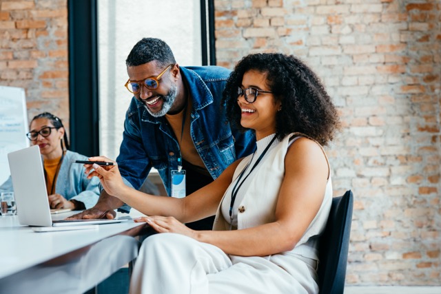 Diverse team members working together in an bright, open office.