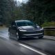 tesla model 3 driving on a wet road