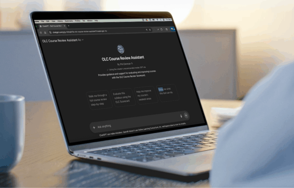 A photo of a laptop screen displaying the chat prompt screen of the OLC Course Review Assistant GPT.